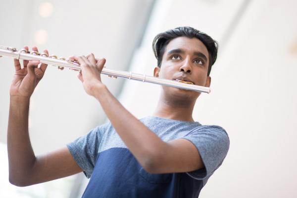 Benefits of the Program - young man playing the flute